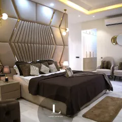 I believe a bedroom should be a personal sanctuary. This master suite features a dramatic, custom-designed geometric headboard in plush, warm tones, creating a focal point that is both luxurious and inviting.