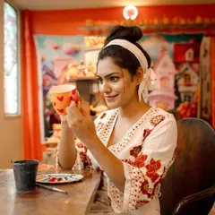 Find your focus and let your creativity flow. Here, a guest is adding personal touches to her ceramic cup, turning a simple object into a piece of her own story.