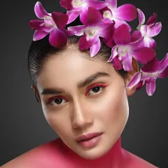 This is from a floral-themed beauty series where we used fresh flowers to create unique looks. The purple orchids and complementary makeup tones create an artistic, high-fashion portrait that is both bold and delicate.