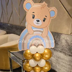 A cute teddy bear and rainbow cutout on a stand of gold and white balloons, perfect as a standalone decoration or centerpiece.