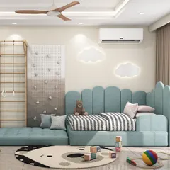 A playful and safe toddler's room with a custom floor-level bed in a soft blue fabric. The room also includes a fun climbing wall and cloud-shaped wall lights to inspire adventure.