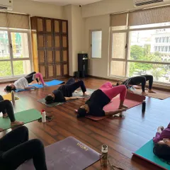 Together, we practice Setu Bandhasana, or Bridge Pose. This asana is excellent for strengthening the pelvic floor, glutes, and back, which provides essential support as your belly grows.