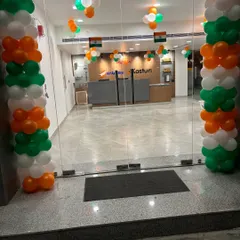 The main entrance of an office decorated for Independence Day. The tricolor balloon pillars make a strong visual statement and welcome everyone into a festive environment.