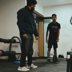 Another moment from a home training session. Here, I'm instructing a client on the proper form for a deadlift with a light barbell, proving you can build strength anywhere.