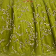 Here's a detailed look at the fabric and embroidery of my neon green lehenga. The intricate threadwork on the silk creates a stunning texture.