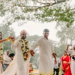 That just-married strut! This candid moment captures the couple's exit from the mandap, hand-in-hand with family, full of joy and tradition.