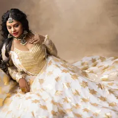 A dreamy shot from a fashion shoot. The model is wearing an oxidized silver-finish choker set that adds a contemporary edge to this beautiful lehenga.