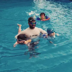 For my infant swimming classes, I am in the water guiding each child, using flotation aids to ensure safety. The focus is on getting them comfortable and happy, building a positive first experience with swimming.
