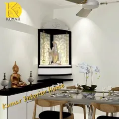 A compact, wall-mounted corner pooja unit in black and white. This space-saving design is perfect for smaller apartments in Mumbai and features elegant chains and backlighting.