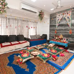 Another angle of the Lagan Lakhwanu setup, showing how all the elements come together in a home setting. The floral arrangements on the ceiling and the traditional textiles create a complete festive transformation of the living space.