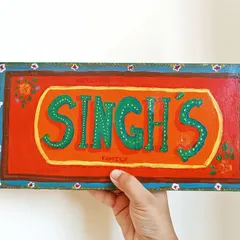 Welcome guests to your home with a personalized name plate. For this piece, I used a bright, folk-art inspired design to create a warm and inviting entrance sign for the Singh family.