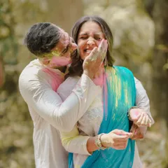 Capturing the laughter and vibrant colors of a playful pre-wedding shoot, this image is full of genuine emotion and joy.