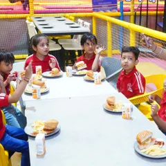 When the jumps make you hungry, we’ve got the yummiest fix. A group of school kids enjoys a well-deserved meal of burgers and fries.