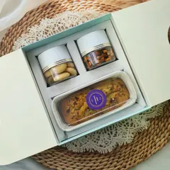 Gifting made easy and elegant. This hamper features my signature Badam Rawa Loaf, classic cookies, and savory peanuts, all in a convenient and stylish carry-box.