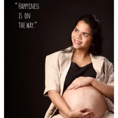 "Happiness is on the way." This portrait combines a beautiful, natural pose showing the baby bump with a simple quote, perfectly capturing the feeling of this special time.