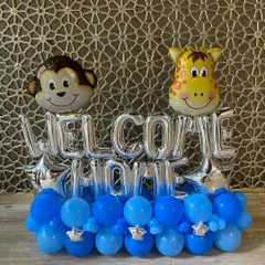 A sweet "Welcome Home" balloon bouquet, perfect for celebrating a new baby. This arrangement features cute monkey and giraffe foil balloons on a base of blue and silver balloons.