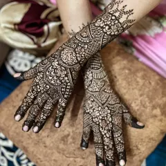 A crossed-hands view, highlighting the symmetry and complementary patterns on both hands for this engagement look.