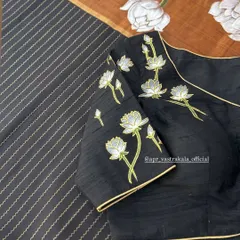An elegant black blouse featuring hand-painted white lotuses. The simplicity of the design and the clean lines make this a sophisticated and modern choice.