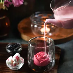 This shot is all about creating a romantic, intimate mood. We used candlelight to cast a warm glow on this rose-infused boba tea, with a gentle pour creating a sense of motion and elegance. The dark, moody styling makes it feel like a special, indulgent treat.