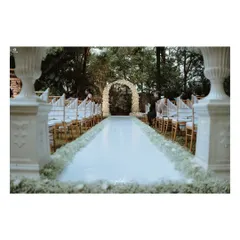 Another perspective of the dreamy Christian wedding setup, with the floral arch and Victorian vases creating a picture-perfect scene.
