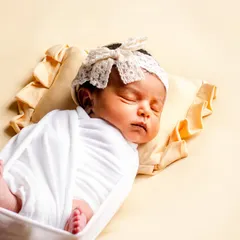 A peaceful, sleeping baby is a beautiful sight. We specialize in safe and comfortable swaddling techniques to keep your newborn snug and content, allowing us to capture these serene moments.