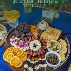 I create visually stunning grazing platters that serve as a centerpiece for any event. This one features a curated selection of artisanal cheeses, fresh fruits like figs and grapes, olives, and assorted crackers, perfect for networking seminars and product launches.