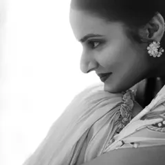 A high-contrast black and white profile of the bride, Sravanthi. This artistic shot emphasizes her features and the delicate details of her attire in a classic, elegant style.