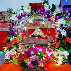 Celebrating the birth of Krishna with a beautifully decorated jhula (swing) for Laddu Gopal. This Janmashtami setup is rich with colorful flowers, small lanterns, and figurines to create a complete scene for the festival.