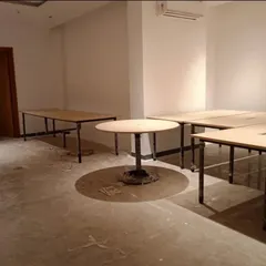 A look at our office tables being set up in a commercial space. This shows the raw, functional furniture before the office is fully decorated.