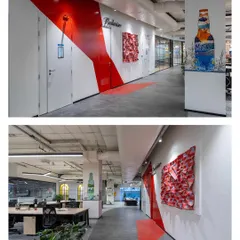 In addition to painted murals, we also create fabric sculptures and other installations. The red piece on the wall is a fabric sculpture that adds texture and dimension, while the painted Budweiser bow and sustainability-themed column art complete the branded hallway.