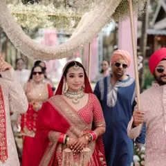 A close up of the bride during her entrance. Her serene expression as she walks under the floral canopy is a moment of pure grace.