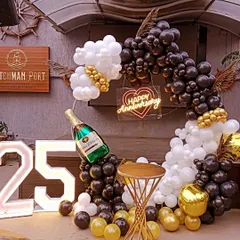 For a sophisticated and modern celebration, I designed this black, white, and gold balloon arch for a 25th anniversary. This setup, complete with a champagne bottle balloon and marquee numbers, is perfect for parties in halls or restaurants.