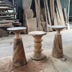 A collection of my sculptural side tables, each hand-turned from a single block of solid wood. These pieces function as both furniture and art, with designs ranging from conical to stacked geometric shapes.