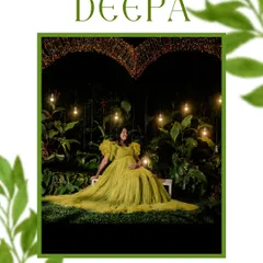 A showcase of our creative night-time maternity shoots. Here, Deepa is seated in a lush garden setting, illuminated by hanging bulbs and a heart-shaped light installation, creating a truly magical and romantic atmosphere.