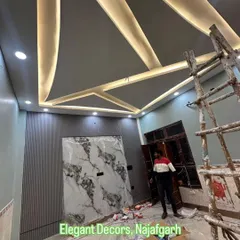 This is a look at a project in progress, showing the complexity I handle. You can see the geometric false ceiling with its lighting framework, a wall featuring grey fluted panels, and a central accent wall prepared for a UV marble sheet. I manage the entire process from start to finish.