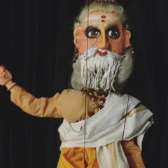 A puppet depicting the sage Kanva from our production of "Abhijnaana Shaakuntalam." The character's wisdom and gentle nature are conveyed through his expressive, hand-painted face and simple attire.