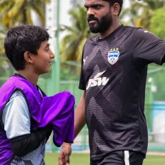 A coach from our Bengaluru FC partnership program offers one-on-one guidance to a U-13 player. This personalized attention is key to developing young talent.