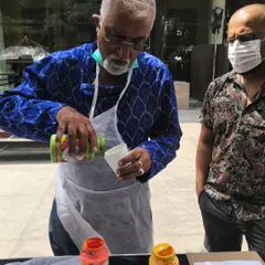 Art is for everyone, at any age. Here, a guest carefully mixes his acrylic paints, getting ready to create his own abstract piece at a weekend flea market event.