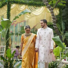 A beautiful moment from a traditional South Indian wedding I designed. The bride's rich Kanjeevaram silk saree and the groom's elegant sherwani are perfectly complemented by the lush, natural decor of the mandap in the background.