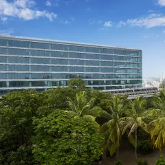 The Godrej Centre Development is situated within a lush green canopy, with an elevated metro line passing by. This image highlights our approach to designing modern workplaces that are connected to urban infrastructure while being buffered by nature.
