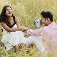 The best moments are often the ones filled with genuine laughter. Here, he captures her with a polaroid camera, and her uninhibited joy makes the photo truly special.