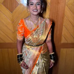 The perfect bridal smile. This bride's radiant happiness is the final touch to her traditional South Indian wedding look, complete with temple jewellery and a vibrant orange Kanjeevaram saree.