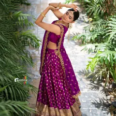 This elegant purple lehenga features a traditional gold border and polka dot pattern, paired with a modern sleeveless blouse. A perfect blend of classic and contemporary design for any celebration.