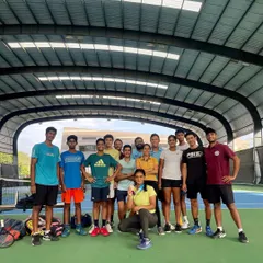 A group photo celebrating a player's bronze medal win at the National Games. We believe in celebrating every success as a team.