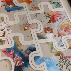 A wider view of the puzzle art, showing how the different elements and color palettes flow together across the panels. The winding path connects each memory, from snowy holidays to sunny road trips.