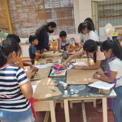 Kids fully engaged in a block printing session during our summer camp. They learn to create patterns using both hand-cut wooden blocks and carved vegetables.