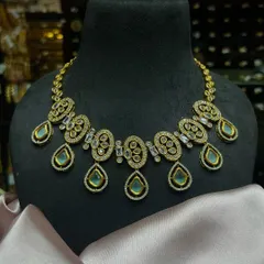 A simple yet elegant Kundan necklace with mint-green drops. This piece is perfect for bridesmaids or for pre-wedding functions like mehendi and haldi.