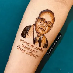 A portrait of Dr. Babasaheb Ambedkar on the forearm, with a quote in Marathi. Creating portraits of respected leaders is an honor, and I focus on capturing their dignified expression.