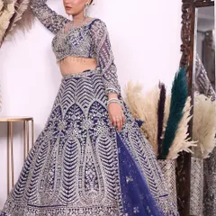 A full-length shot of the royal blue and silver lehenga, showcasing its grand silhouette and how the detailed embroidery extends down the entire skirt.
