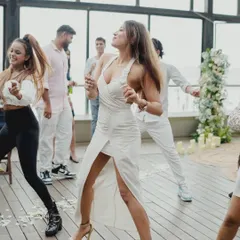 Pure energy and happiness radiating from the bride-to-be during her surprise proposal performance. This candid shot is all about capturing the peak emotion of the celebration.